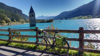 Fahrrad vor dem Reschensee mit dem Kirchturm im See